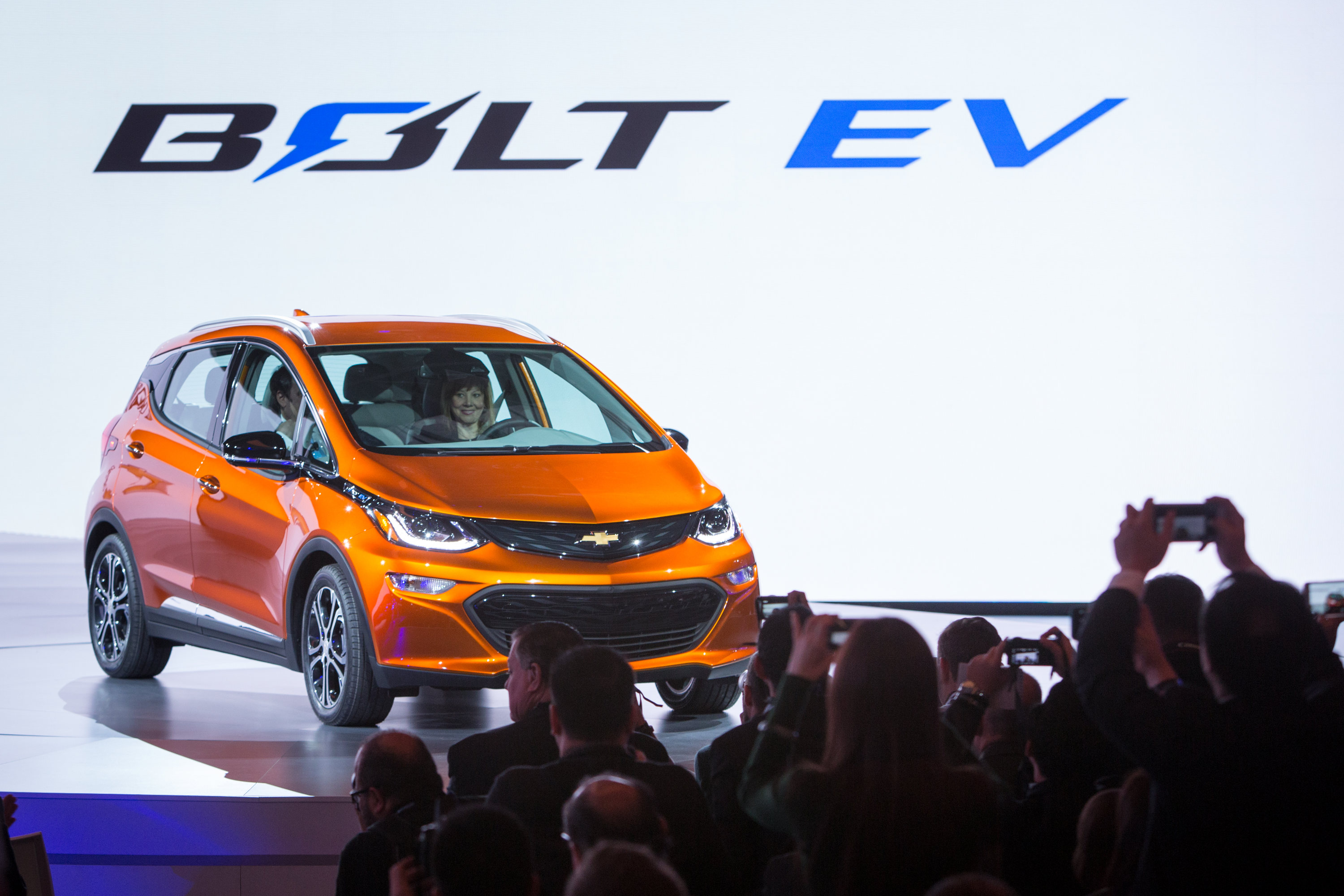 General Motors Chairman and CEO Mary Barra drives the 2017 Chevrolet Bolt EV onto the stage Monday, January 11, 2016 at the North American International Auto Show in Detroit, Michigan. GM Executive Vice President Product Development Mark Reuss rides in the passenger seat. The Bolt EV offers more than 200 miles of range on a full charge at a price below $30,000 after Federal tax credits. (Photo by Jeffrey Sauger for Chevrolet)